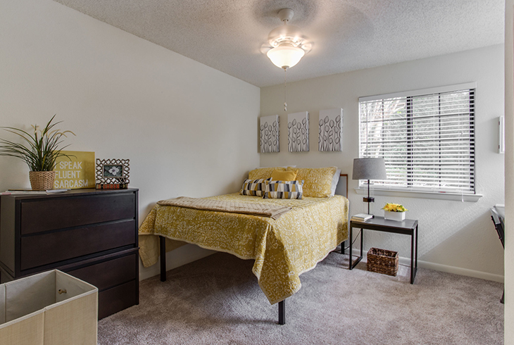 Furnished apartment bedroom decorated with yellow decor