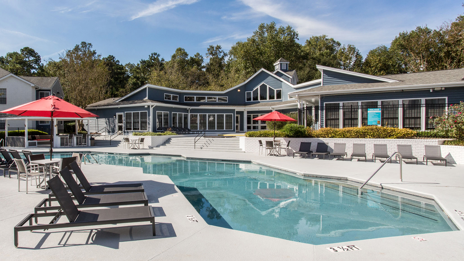 Resort style pool surrounded by lounge chairs