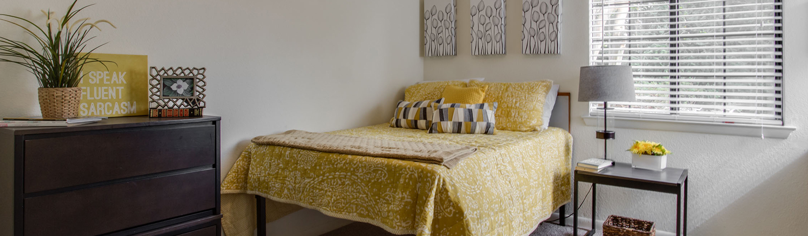 Furnished apartment bedroom decorated with yellow accents